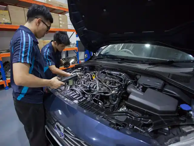 Technicians checking an engine bay